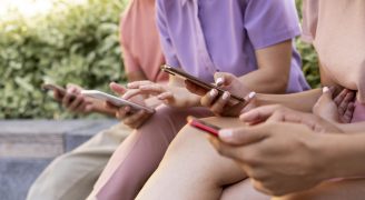 close-up-friends-holding-smartphones